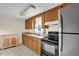 Traditional kitchen with wooden cabinets, double sink, and appliances at 1007 Grace Ave, Burlington, NC 27217