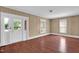Bright living room with hardwood floors, natural light and a view of the front yard, plus a white trimmed doorway at 1007 Grace Ave, Burlington, NC 27217