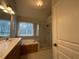 Bright bathroom with double sink vanity, separate shower, and soaking tub near a window at 1021 Golden Star Way, Wake Forest, NC 27587