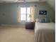 Large bedroom with slanted ceiling, carpet, a window and neutral paint at 1021 Golden Star Way, Wake Forest, NC 27587