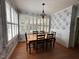 Bright dining room with hardwood floors, white trim, designer wallpaper, and large windows at 1021 Golden Star Way, Wake Forest, NC 27587