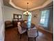 Elegant dining room featuring tray ceilings, hardwood floors, and a chandelier at 1021 Golden Star Way, Wake Forest, NC 27587
