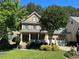 Charming two-story brick home featuring a well-manicured lawn and inviting front porch at 1021 Golden Star Way, Wake Forest, NC 27587