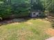 Large backyard with a wooden shed and a partial fence line at 106 Chariot Dr, Sanford, NC 27330