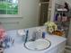 Bright bathroom featuring a large mirror, storage, and a window at 106 Chariot Dr, Sanford, NC 27330