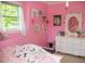Bright pink bedroom featuring a large window and white furniture at 106 Chariot Dr, Sanford, NC 27330