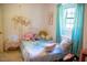 Cozy bedroom with a window, curtains, and whimsical decor at 106 Chariot Dr, Sanford, NC 27330