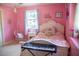 Bright, pink bedroom featuring a keyboard, and a hanging chair at 106 Chariot Dr, Sanford, NC 27330