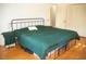 Cozy bedroom featuring hardwood floors, neutral walls, and a comfortable iron frame bed at 106 Chariot Dr, Sanford, NC 27330