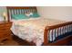 Bedroom with wooden bed frame, matching nightstand and hardwood floors at 106 Chariot Dr, Sanford, NC 27330
