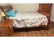 Bedroom with wooden bed frame, matching nightstand, dresser, and hardwood floors at 106 Chariot Dr, Sanford, NC 27330