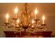 Close-up of an ornate dining room chandelier with candle lighting and crystal pendants at 106 Chariot Dr, Sanford, NC 27330