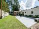 Private backyard featuring a patio, lush lawn, and mature trees at 110 W Parker St, Smithfield, NC 27577