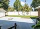 Spacious backyard featuring a concrete patio, fire pit, and grassy area, perfect for outdoor living at 110 W Parker St, Smithfield, NC 27577
