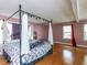 Spacious bedroom featuring wood floors, pink walls, and a canopy bed at 110 W Parker St, Smithfield, NC 27577