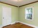 Bedroom with hardwood floors, a closet, and a large window at 110 W Parker St, Smithfield, NC 27577