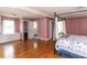 Spacious bedroom with wood floors, built in storage, and a canopy bed at 110 W Parker St, Smithfield, NC 27577