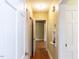 A hallway featuring hardwood floors, and multiple access doors at 110 W Parker St, Smithfield, NC 27577