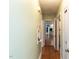Hallway with hardwood flooring, and access to other rooms, showing the home's layout at 110 W Parker St, Smithfield, NC 27577
