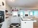 Bright kitchen featuring white cabinets, black accents, and an adjoining dining area at 110 W Parker St, Smithfield, NC 27577
