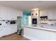Well-lit kitchen with white cabinets, black and white tiled backsplash, and an attached breakfast bar at 110 W Parker St, Smithfield, NC 27577