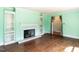Inviting living room featuring a decorative fireplace, built-in shelving and hardwood floors at 110 W Parker St, Smithfield, NC 27577