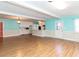 Bright open space featuring a white brick fireplace, laminate floors and a kitchen area with white cabinets at 110 W Parker St, Smithfield, NC 27577