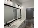Bathroom features a double vanity with modern fixtures and a view of the tiled shower and toilet at 118 Sanderway Dr, Chapel Hill, NC 27516