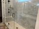 Bathroom featuring a glass shower with bench and stylish tile work at 118 Sanderway Dr, Chapel Hill, NC 27516