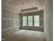 Unfinished bedroom features trey ceilings and triple windows overlooking a wooded backyard at 118 Sanderway Dr, Chapel Hill, NC 27516