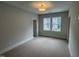 Bedroom with neutral walls and plush carpet features two windows for plenty of light at 118 Sanderway Dr, Chapel Hill, NC 27516
