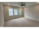 Spacious bedroom features plush carpeting, a ceiling fan, and bright, natural light at 118 Sanderway Dr, Chapel Hill, NC 27516