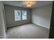 Carpeted bedroom featuring neutral walls and two windows offering plenty of natural light at 118 Sanderway Dr, Chapel Hill, NC 27516