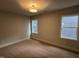 Bedroom with carpeted floors, base trim, and two windows offering plenty of natural light at 118 Sanderway Dr, Chapel Hill, NC 27516