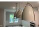Dining room with modern pendant lights and large windows offering serene views at 118 Sanderway Dr, Chapel Hill, NC 27516