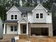 New construction with brick foundation, gray siding, and an attached 2-car garage at 118 Sanderway Dr, Chapel Hill, NC 27516