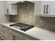 Modern kitchen showcasing white cabinetry, stylish hardware, quartz countertops, and a gas range at 118 Sanderway Dr, Chapel Hill, NC 27516
