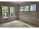 Bright, unfurnished room with classic trim, large windows offering views of the wooded backyard at 118 Sanderway Dr, Chapel Hill, NC 27516