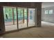 Spacious room with wall paneling that leads to a screened porch with outdoor views at 118 Sanderway Dr, Chapel Hill, NC 27516