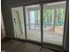 View of a covered porch with wooden decking as seen through sliding glass doors at 118 Sanderway Dr, Chapel Hill, NC 27516