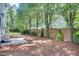 Backyard showing a fenced yard with a paver patio and mature trees, ideal for outdoor activities at 120 Hatchet Creek Ct Ct, Morrisville, NC 27560