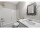 Clean bathroom features white tiled shower/tub and decorative mirror above a large sink at 120 Hatchet Creek Ct Ct, Morrisville, NC 27560