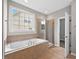 Bathroom features large tub, shower, and window for natural light at 120 Hatchet Creek Ct Ct, Morrisville, NC 27560