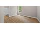 Bedroom with hardwood floors, natural light, and attached bathroom for convenience at 120 Hatchet Creek Ct Ct, Morrisville, NC 27560