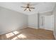 Empty bedroom features a ceiling fan, hardwood floors, and an adjoining door to the bathroom at 120 Hatchet Creek Ct Ct, Morrisville, NC 27560