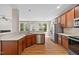 Open-concept kitchen with wood cabinets, stainless steel appliances, and elegant quartz countertops at 120 Hatchet Creek Ct Ct, Morrisville, NC 27560