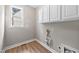 Bright laundry room with white cabinets and window, offering a clean and functional space at 120 Hatchet Creek Ct Ct, Morrisville, NC 27560