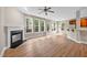 Open-concept living room featuring a fireplace, large windows, and a breakfast bar at 120 Hatchet Creek Ct Ct, Morrisville, NC 27560