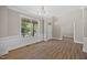 Spacious, bright living room featuring large window, hardwood floors and elegant chandelier at 120 Hatchet Creek Ct Ct, Morrisville, NC 27560