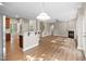 Open floor plan with hardwood floors, seamlessly connecting the kitchen, dining, and living areas at 120 Hatchet Creek Ct Ct, Morrisville, NC 27560
